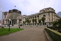 Modern expansion of conic Beehive in gray concrete to old Edwardian parliament on podium, Wellington, New Zealand