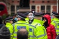 PARLIAMENT SQUARE, LONDON, ENGLAND- 14 December 2020: Protester wearing an anonymous mask at an anti-lockdown protest
