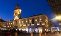 Parma city hall illuminated at dusk and monument