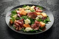 Parma ham and melon salad with mozzarella, green leaves mix Royalty Free Stock Photo