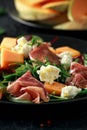 Parma ham and melon salad with mozzarella, green leaves mix Royalty Free Stock Photo