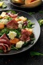 Parma ham and melon salad with mozzarella, green leaves mix Royalty Free Stock Photo