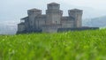 Parma - Italy - castle of Torrechiara through windy meadow vale panorama - Emilia Romagna region