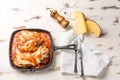 Parmegiana Steak also known as Filet Parmegiana in a black iron pan on a wooden white background, cheese and tomato sauce. Soft Royalty Free Stock Photo