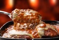 Parmegiana Steak  also known as Filet Parmegiana in a black iron pan on a wooden fire background out of focus, cheese and Royalty Free Stock Photo