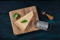 Parmesan cheese with basil, a knife, and a grater, a flat lay top shot Royalty Free Stock Photo