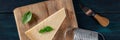 Parmesan cheese panorama, with basil leaves, a knife, and a grater Royalty Free Stock Photo