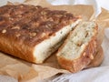 Parmesan and garlic white bread with a golden brown crust in parchment. Homemade bread making