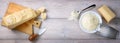 Parmesan pieces and grated on wooden table, top view, space for text.