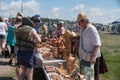 Trade in Souvenirs from birch bark at the fair during the ethnic festival Karatag on the shore of a Large lake Royalty Free Stock Photo
