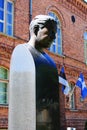 Monument to Estonian chess player Paul Keres on the background of a red brick building