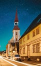 Parnu, Estonia. Night View Of Kuninga Street With Old Houses In Evening Night Illuminations. Bold Bright Blue Starry Sky