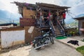 Paro, Bhutan - October 24, 2021: Art shop in an old rather dilapidated traditional house. Indian Royal Enfield motorcycle and a