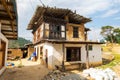 Paro, Bhutan - October 24, 2021: Decrepit looking farm house. Traditional Bhutanese architecture. Wooden roof protected by