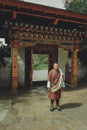 Paro, Bhutan - September 10, 2016: Bhutanese man in traditional clothings standing in front of the door in Kichu Lhakhang temple.