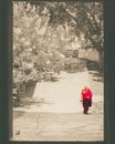 Paro, Bhutan - September 10, 2016: Bhutanese monk walking through the door in Kichu Lhakhang temple.