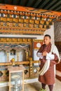 Paro, Bhutan - September 10, 2016: Local Bhutanese tourist guide wearing traditional clothing standing in a temple.