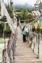 Paro, Bhutan - September 14, 2016: Tourists on the Iron Bridge of Tamchog Lhakhang Monastery, Paro River, Bhutan.