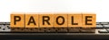 PAROLE word made with building blocks. A row of wooden cubes with a word written in black font is located on a black keyboard