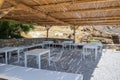 Tables and chairs at the local tavern on the Monastiri beach. Paros island, Cyclades, Greece