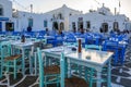 Tables and chairs in seaside fish restaurant in beautiful Naoussa harbor on Paros Island.