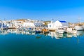 A view of Naoussa port with Greek style church and traditional fishing boats, Paros island, Cyclades, Greece