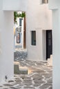 Paros island, Greece. Naousa old town. Whitewashed building, empty narrow cobblestone alley Royalty Free Stock Photo