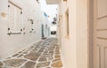 Paros island, Greece. Whitewashed building, empty narrow cobblestone street at Naousa old town Royalty Free Stock Photo