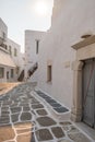 Paros island, Greece. Whitewashed building, empty narrow cobblestone street at Naousa old town Royalty Free Stock Photo