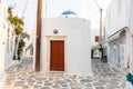 Paros island, Greece. Whitewashed building, empty narrow cobblestone street at Naousa old town Royalty Free Stock Photo