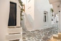 Paros island, Greece. Whitewashed building, empty narrow cobblestone street at Naousa old town Royalty Free Stock Photo