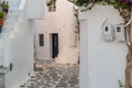 Paros island, Greece. Whitewashed building, empty narrow cobblestone street at Naousa old town Royalty Free Stock Photo