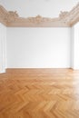 Parquet floor , white walls and stucco ceiling in empty room after renovation Royalty Free Stock Photo