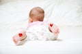 Parrents love concept. baby infant lying in the bed with heart o Royalty Free Stock Photo