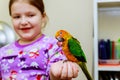 parrot sitting on a girls hand Royalty Free Stock Photo