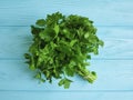 Parsley bunches on a blue wooden seasoning