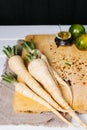 Parsley root with tomatoes on cutting board on a white background of the old wooden boards vintage top view, diet healthy vegetabl Royalty Free Stock Photo