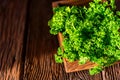 Parsley in wooden box on wooden background close Royalty Free Stock Photo