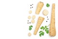 Parsnip root and slices with parsley peppercorns isolated on white background with copy space for your text. Top view Royalty Free Stock Photo