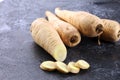 Parsnip root and slices on rustic background. Fresh raw organic parsnip