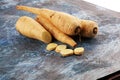 Parsnip root and slices on rustic background. Fresh raw organic parsnip