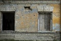 Part of abandoned building with two broken windows Royalty Free Stock Photo