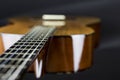 Part of a orange acoustic guitar on black background close-up shot swallow FOD Royalty Free Stock Photo