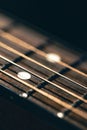 Part of an acoustic guitar, guitar fretboard on a black background. Royalty Free Stock Photo