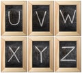 Part of the alphabet drawing with chalk on the old scratched chalkboard background with wooden frame. Letters: U, V, W