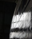 Part of the aluminum fuselage of the aircraft with rivets and portholes.