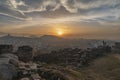 Part of ancient fortress wall on top of the Nebet tepe Hill in Plovdiv city, Bulgaria. Panoramic view with sunset. Foggy winter