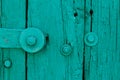 The Part of Aquamarine Old Vintage Door with Crack Paint and Big Steel Bolt with and Nuts,Texture,Background Royalty Free Stock Photo