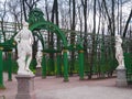 Part of arched lattices with sculptures in the park of the Summer Garden in early spring April in St. Petersburg
