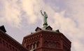 Part of the Basilica of Saint Louis the King with a statue of Saint Francis on the dome.